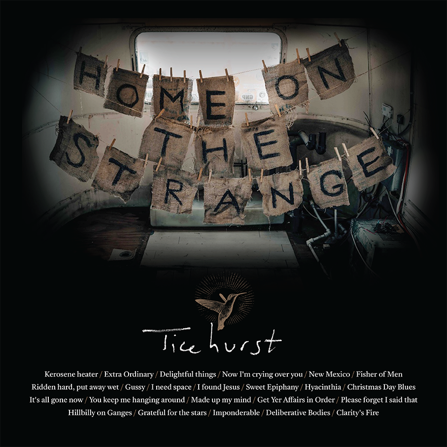 Album artwork depicting the album name, Home On The Strange, spelled on out tattered pieces of cloth hanging on lines of twine. Below the image is a list of all the songs on the album.