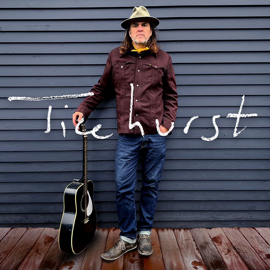 Album artwork depicting Tim standing with a hand in pocket and other holding the head of guitar that rests on the ground. His last name, Ticehurst, is overlayed over the image.